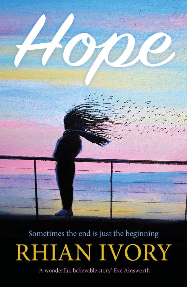 A woman standing on a pier with her hair flowing in the wind against a colourful sunset sky, symbolising hope and new beginnings.