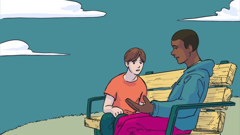 Two young people sitting on a park bench, engaging in a conversation outdoors on a cloudy day.
