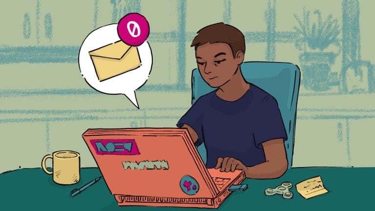 A young person working on a laptop with no notifications, surrounded by a coffee mug, coins, and a notepad, in a home or office setting.